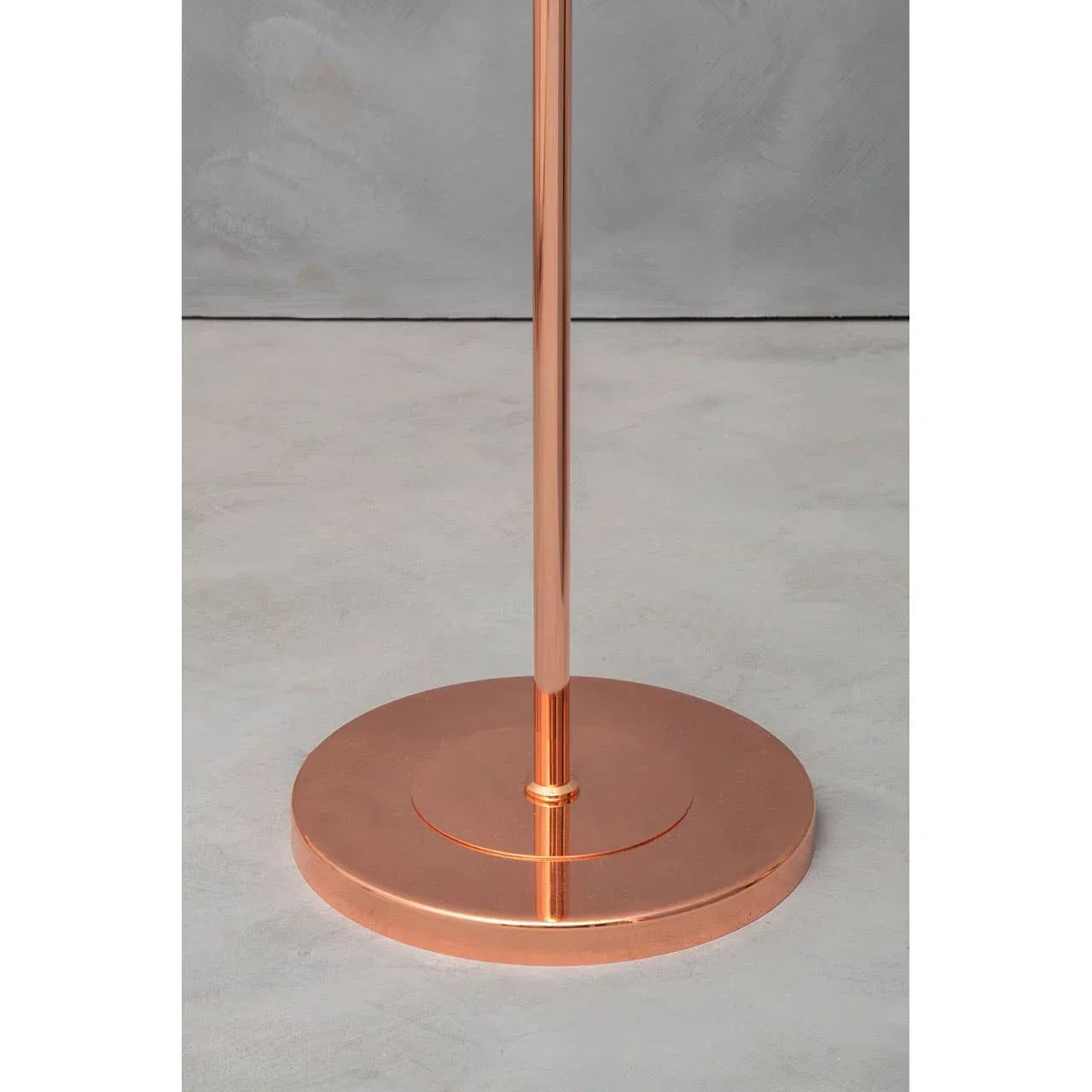 Copper metal floor lamp base on light grey surface