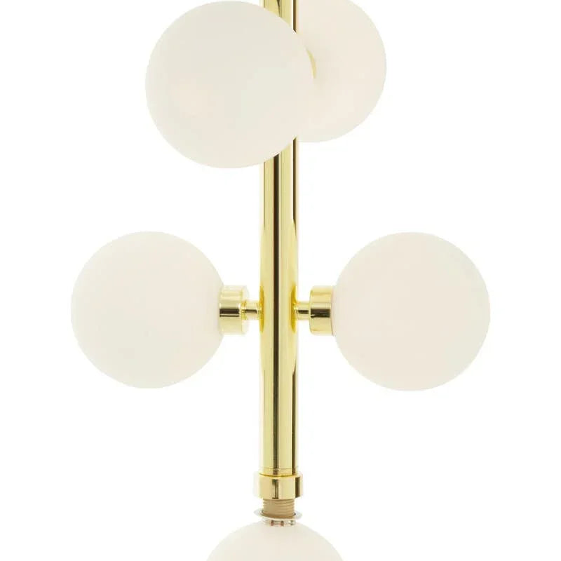 Gold chandelier with frosted glass globes in modern vertical arrangement