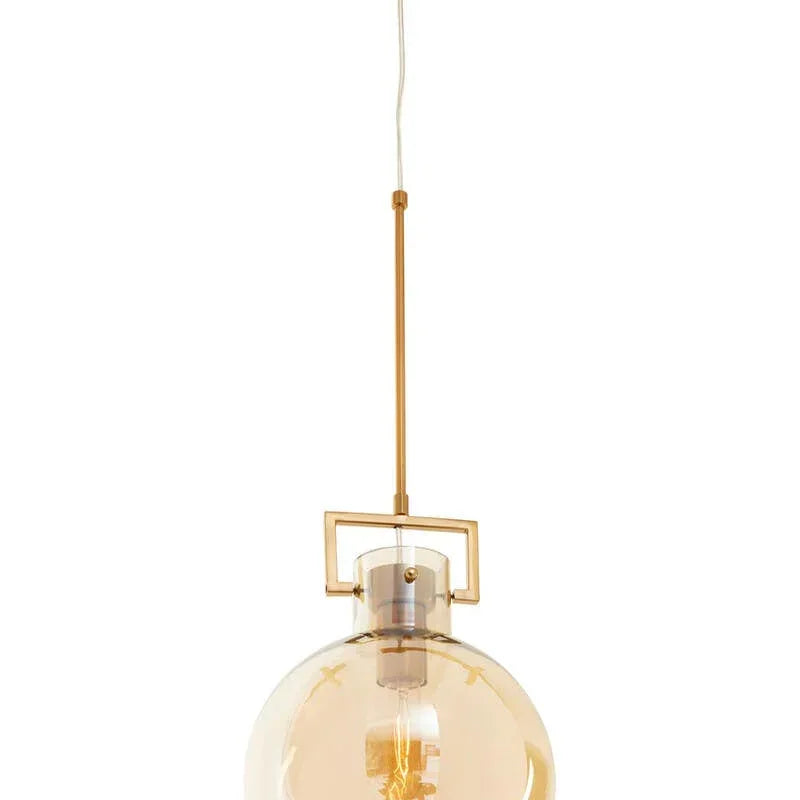 Amber glass globe pendant light with gold ceiling mount and exposed bulb