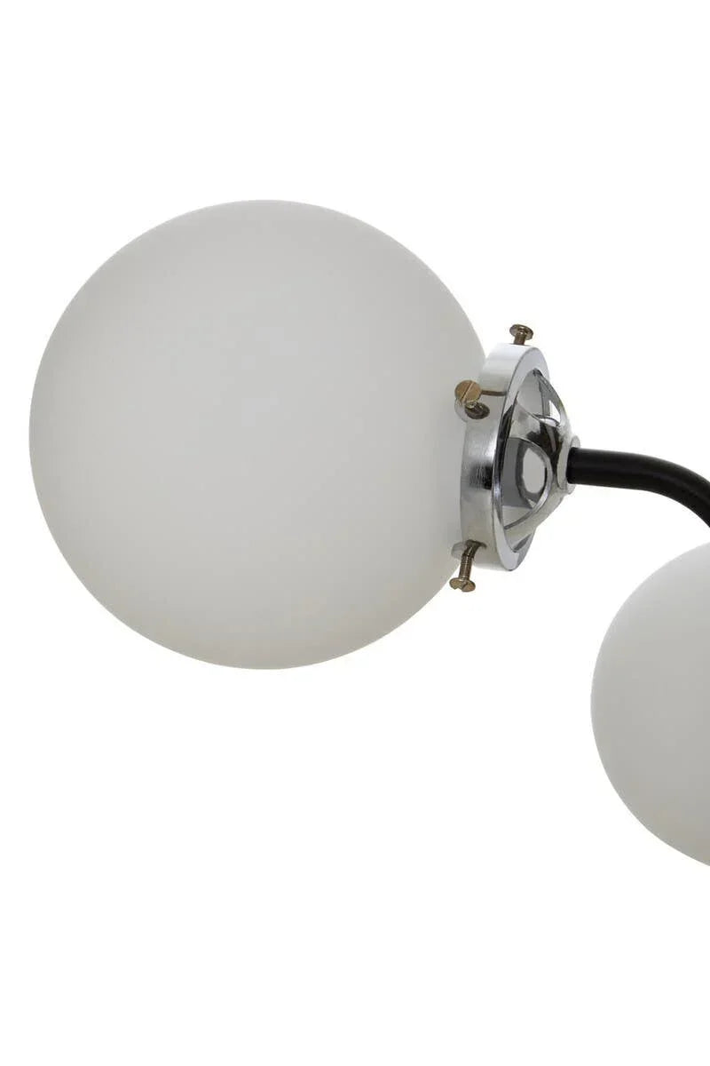 Close-up of frosted glass globe lampshade with chrome fixture on modern wall light