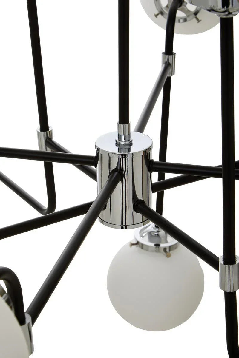 Close detail of modern chandelier with chrome frame and frosted glass globe light shade