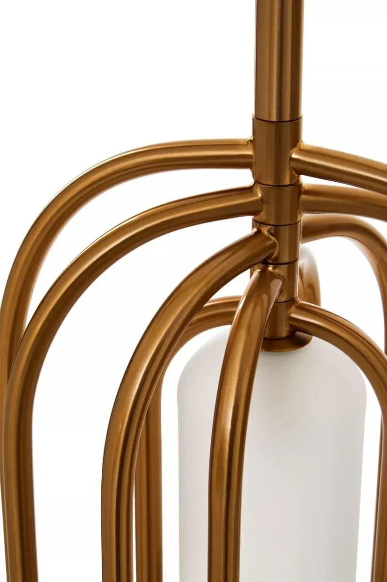 Close-up of gold metal lamp base with white cylindrical shade