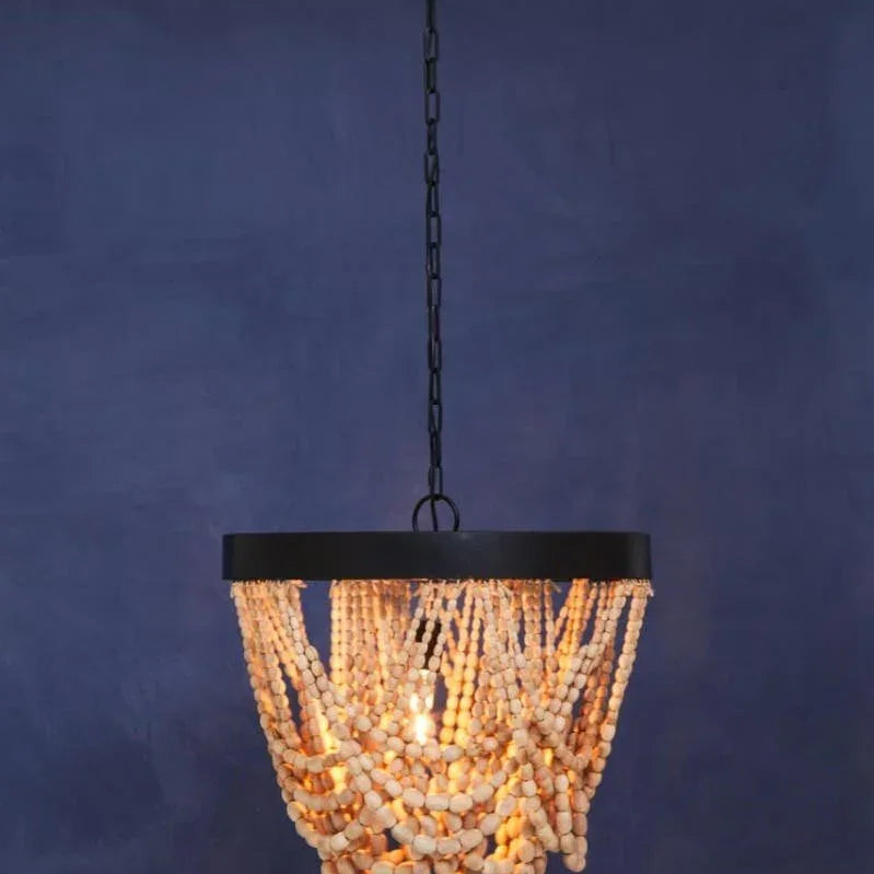 Wood bead chandelier with black metal frame and hanging chain against blue wall