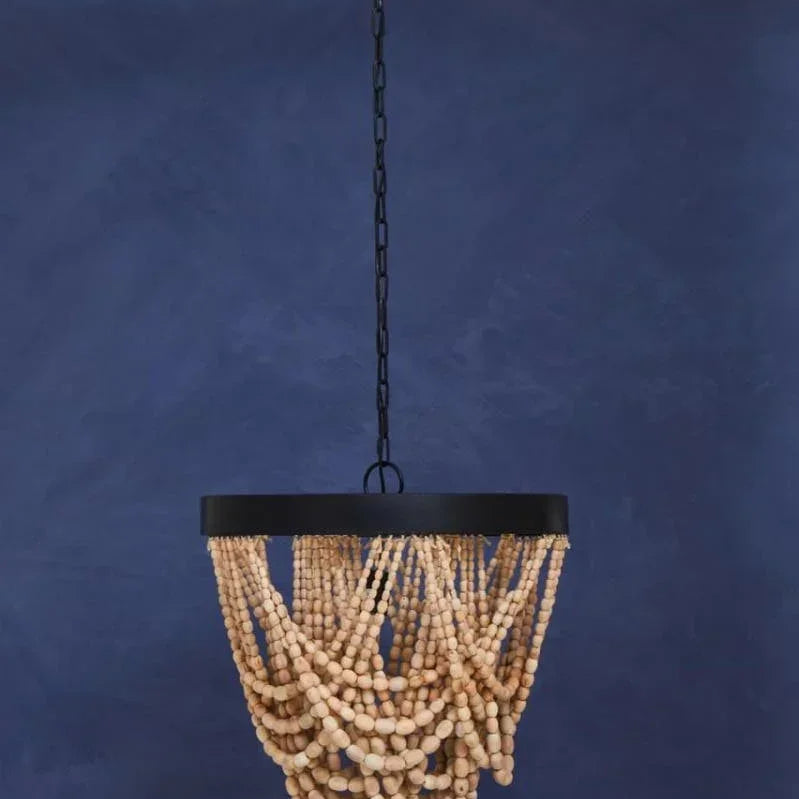 Wooden bead chandelier light fixture with black metal frame against blue wall