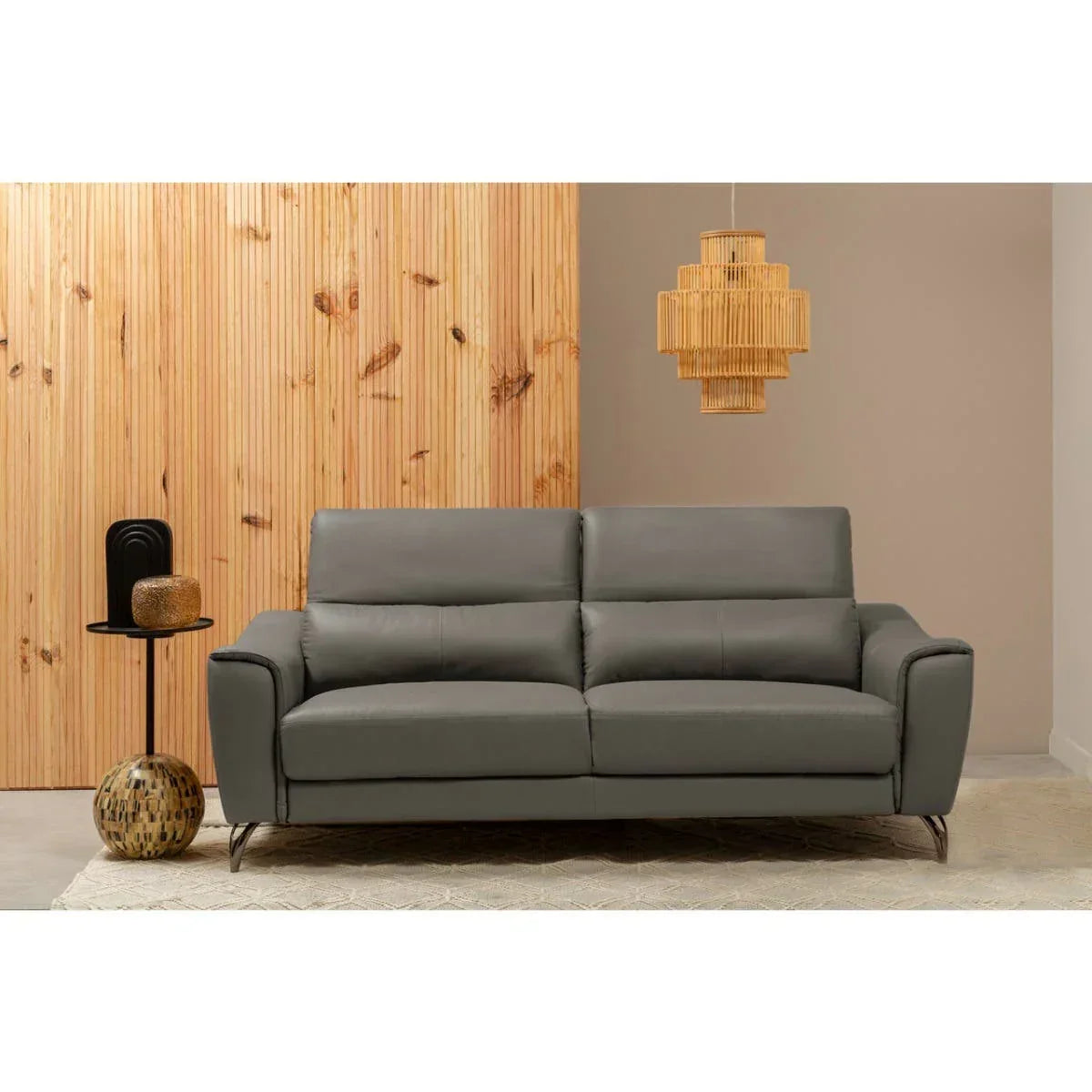 Grey leather sofa with metal legs in modern living room, wood panel wall, pendant light