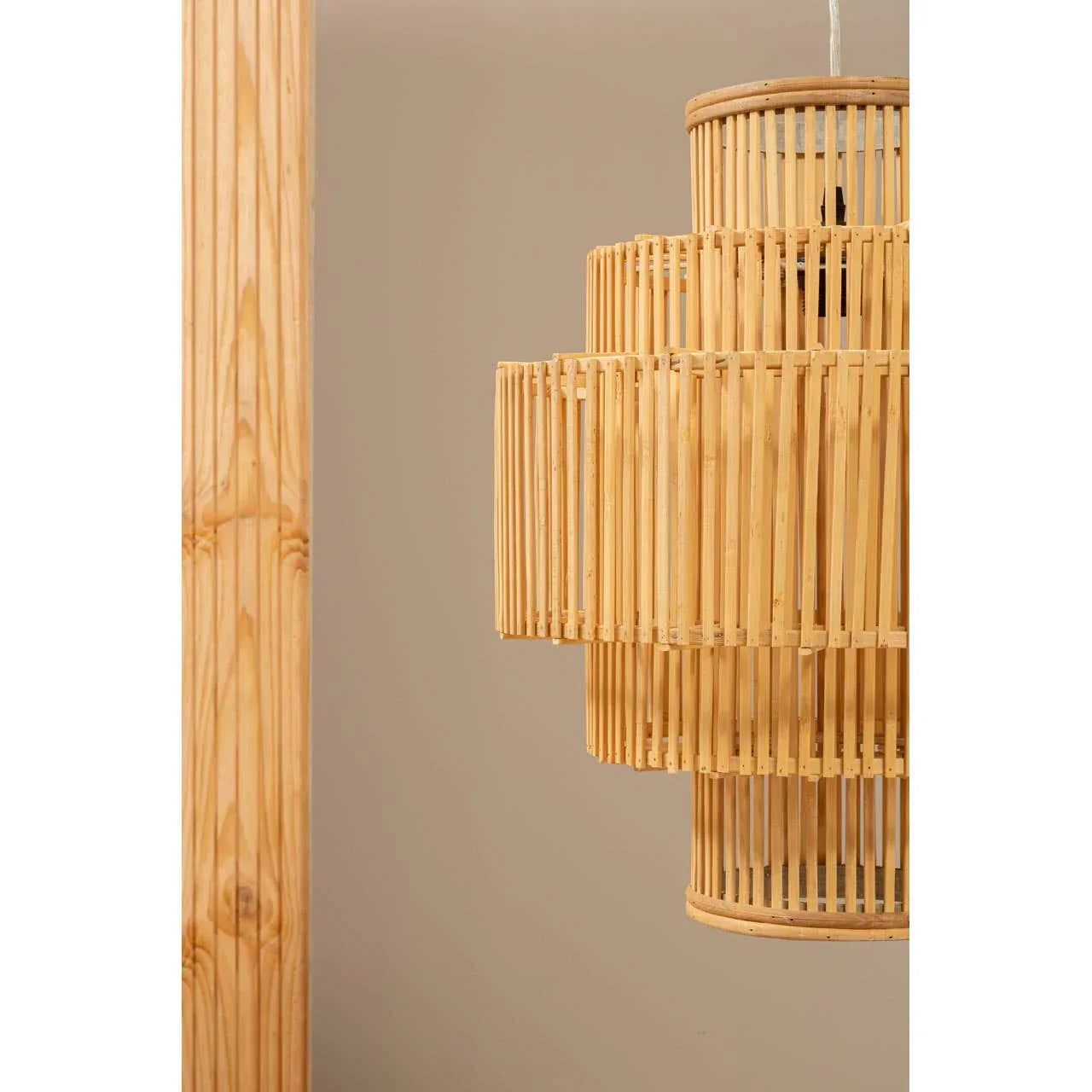 Natural bamboo pendant light with layered design against neutral wall background