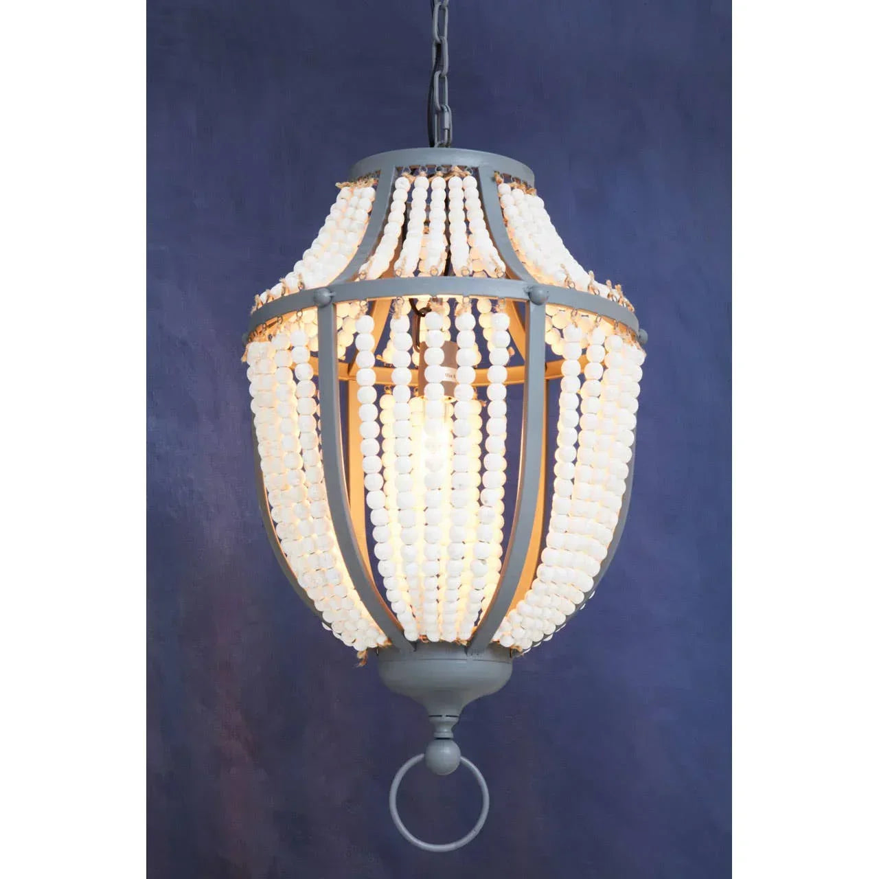 Beaded pendant ceiling light with grey frame against dark blue wall