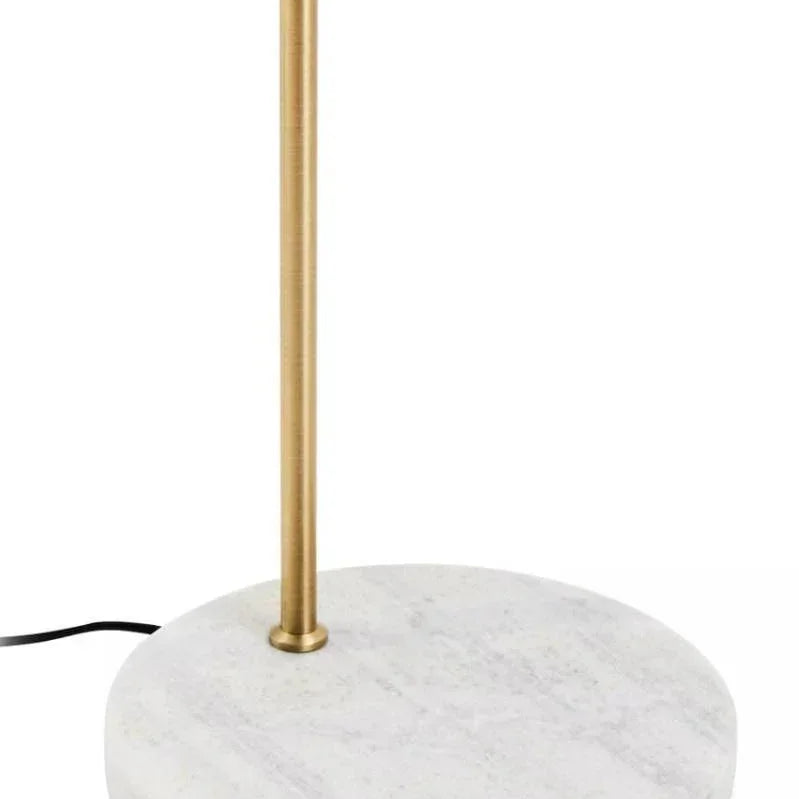 Brass floor lamp with round white marble base, close-up of base and upright stand