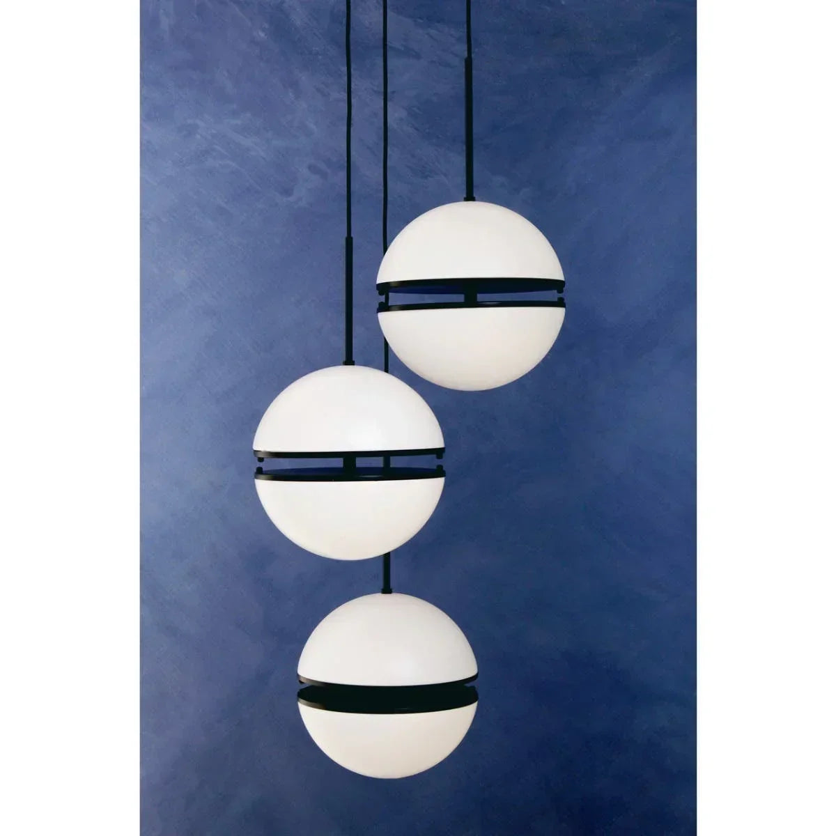 modern spherical pendant lights with black bands against blue wall