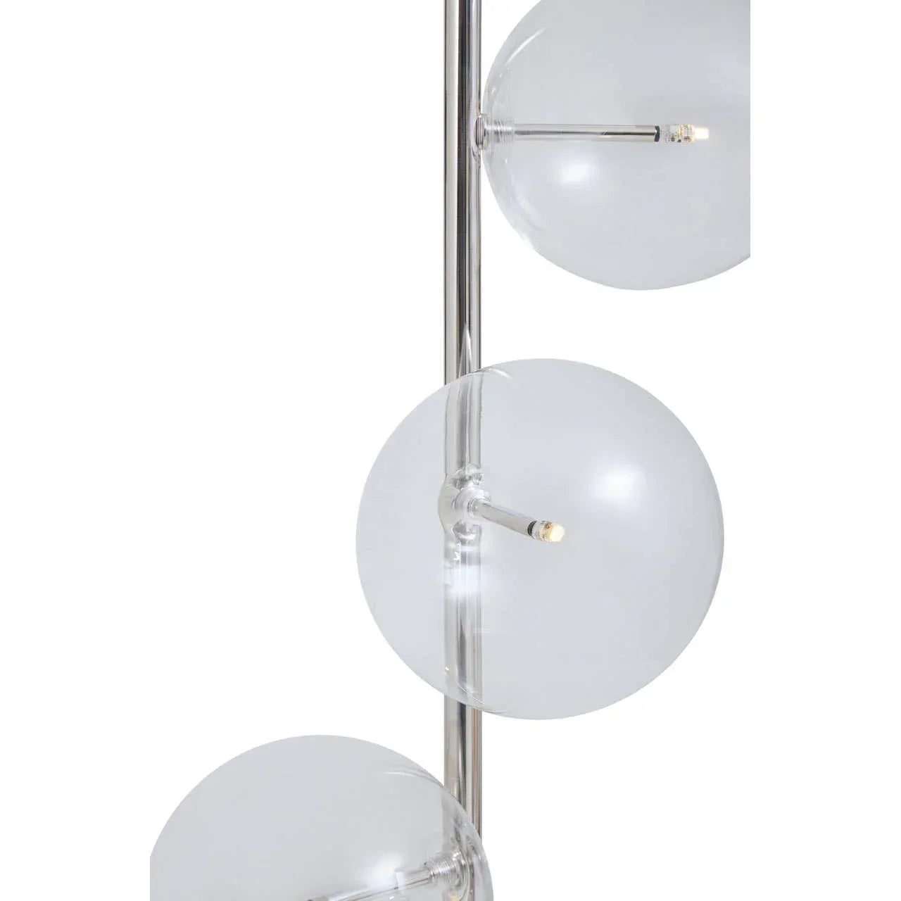Close-up of modern glass globe floor lamp with chrome finish and LED light details