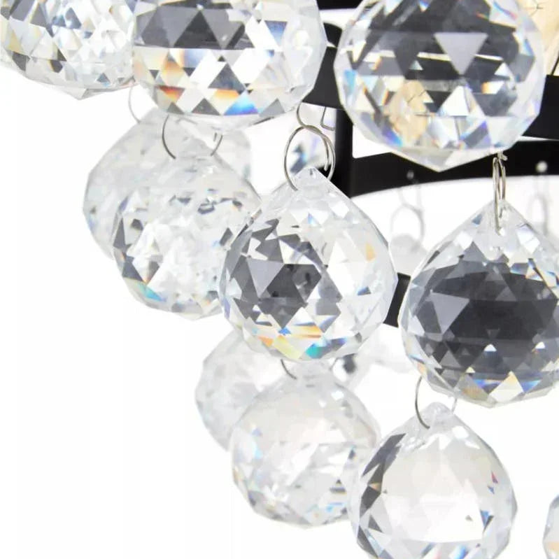 Close-up of crystal chandelier drops hanging from metal frame