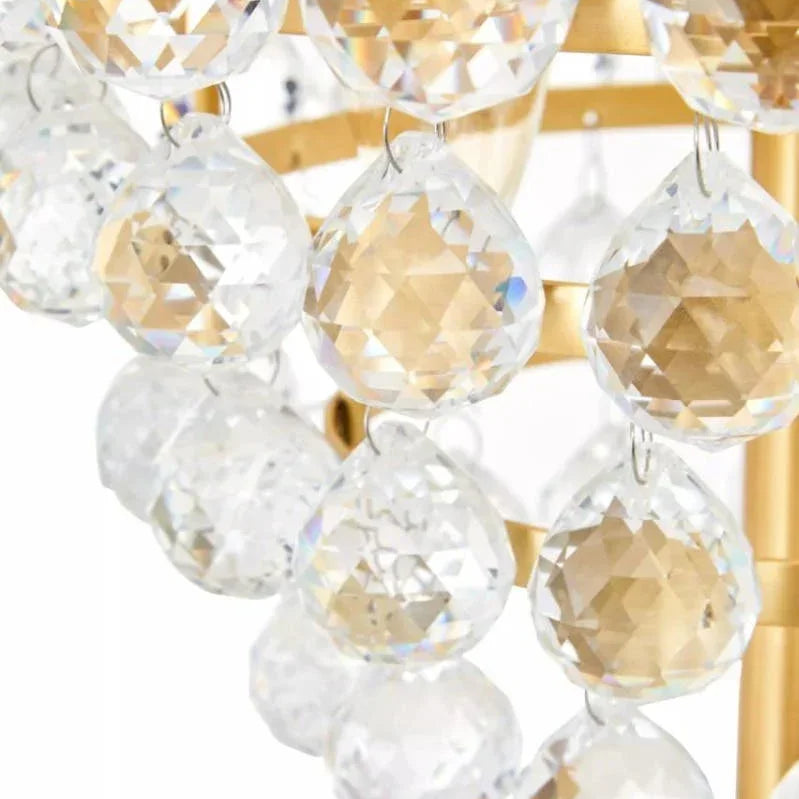 Close-up of crystal chandelier droplets on gold frame lighting fixture