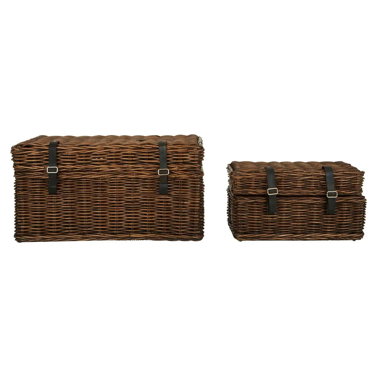 Set of two brown wicker storage trunks with black buckle straps on white background