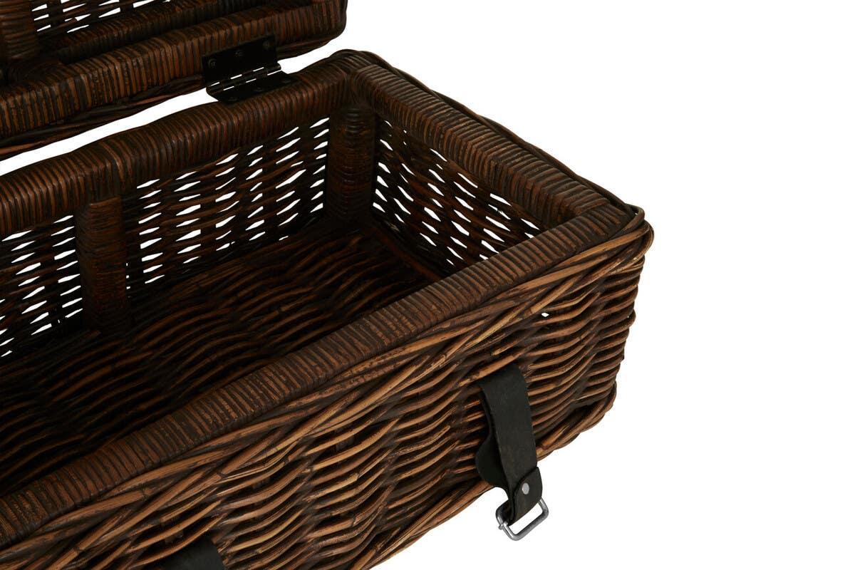 Open brown wicker storage basket with leather strap and metal buckle detail