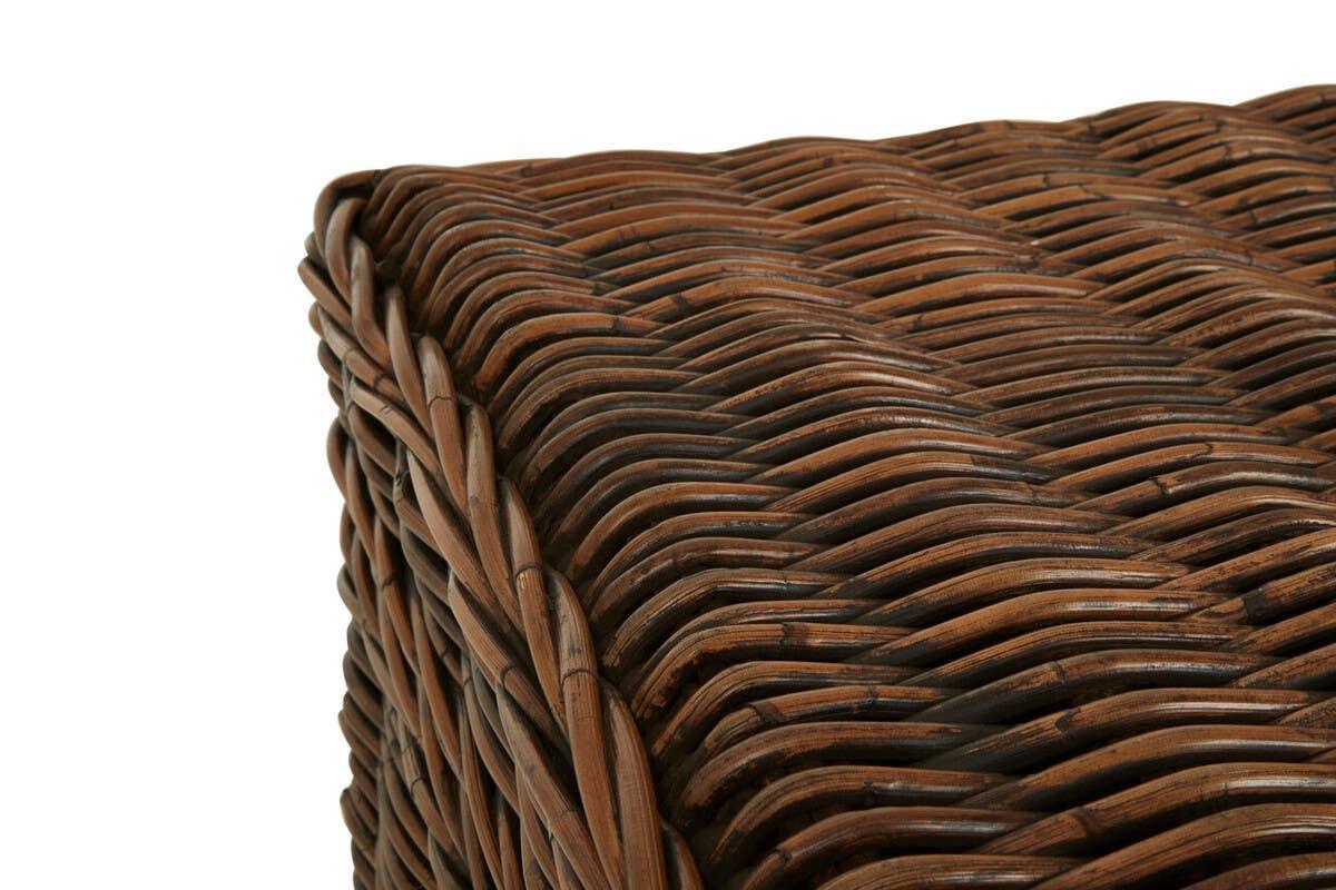 Close-up of rattan furniture corner showing detailed brown woven texture and sturdy edges