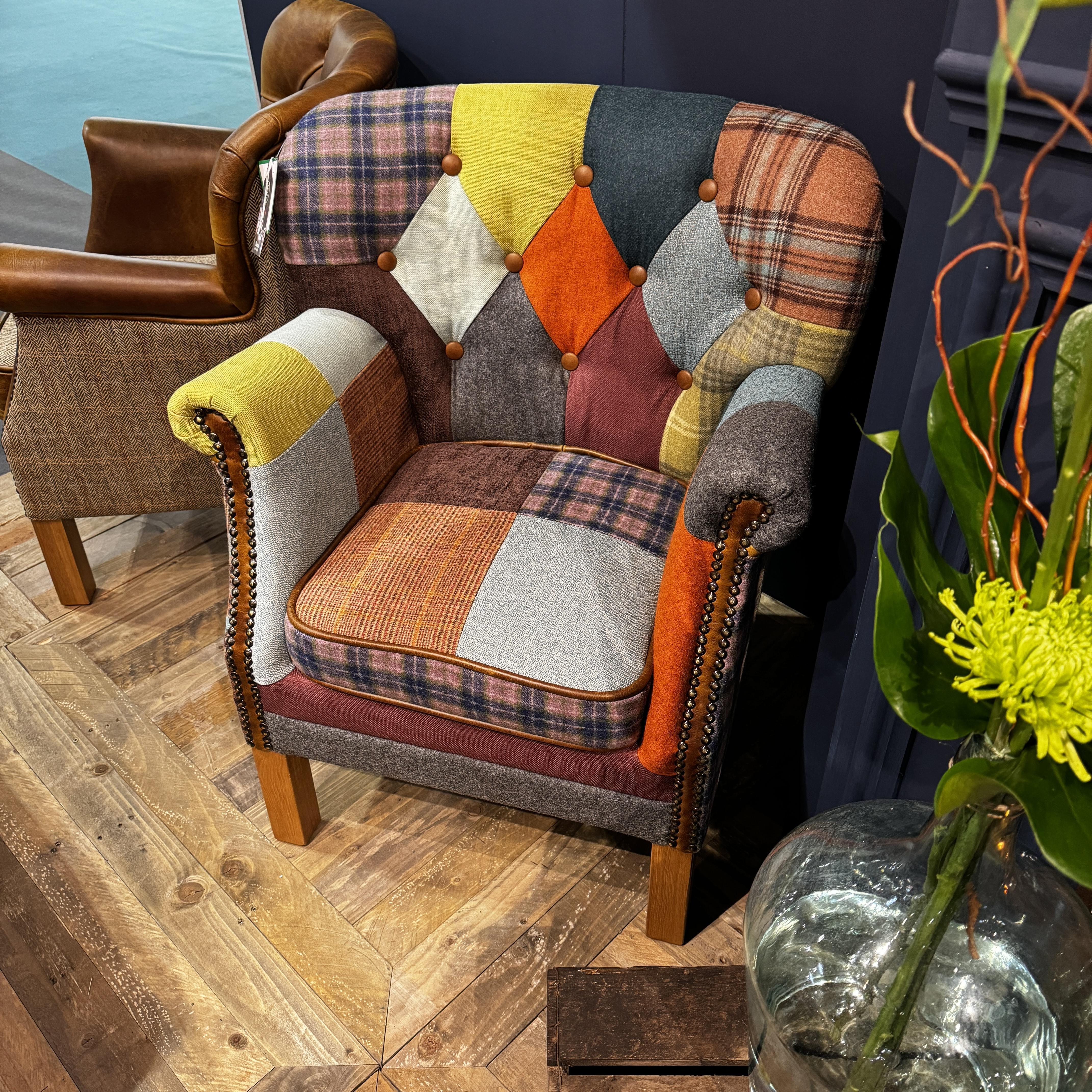 Patchwork accent armchair with wooden legs and button detailing on patterned upholstery