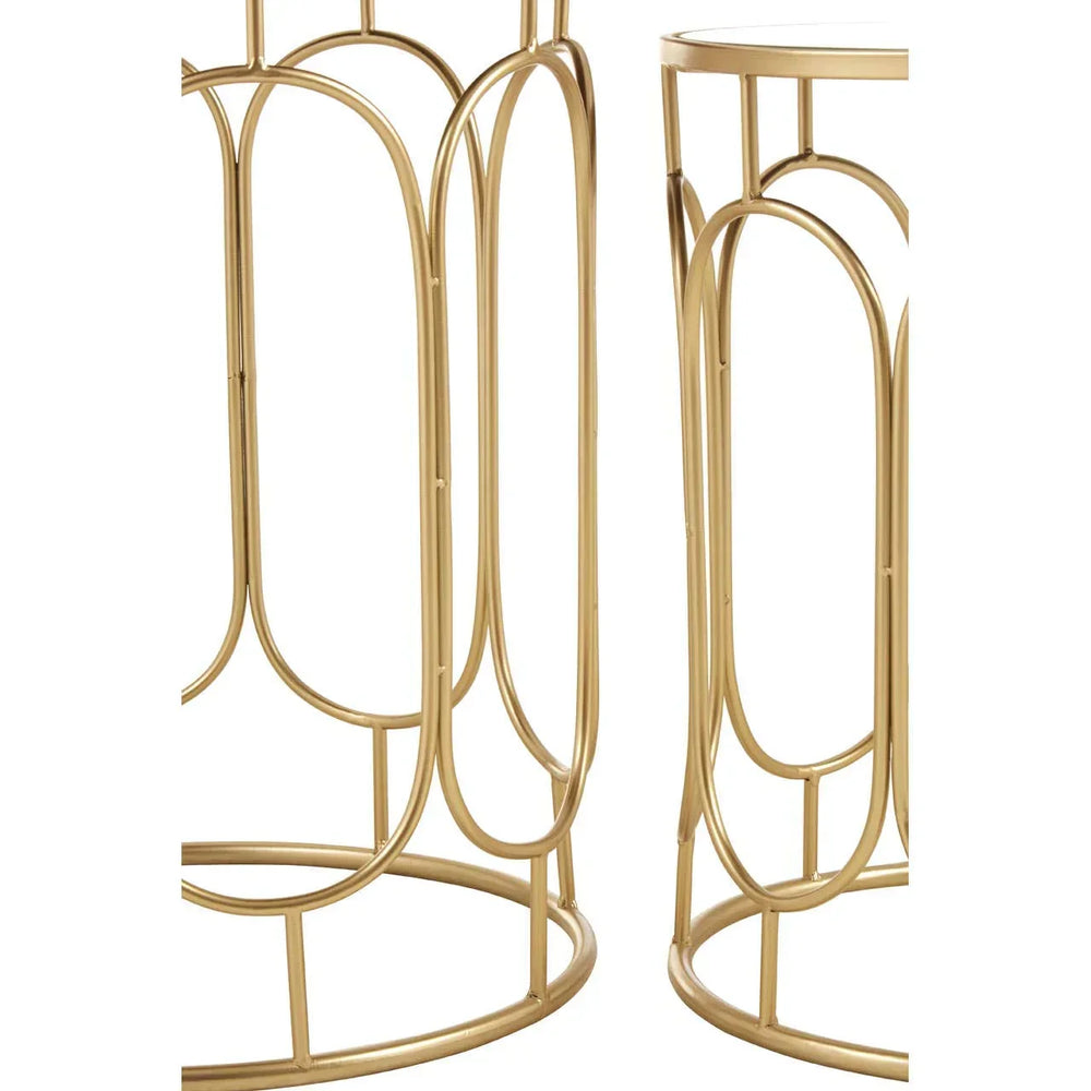 Gold metal side tables with geometric openwork bases shown from a close angle