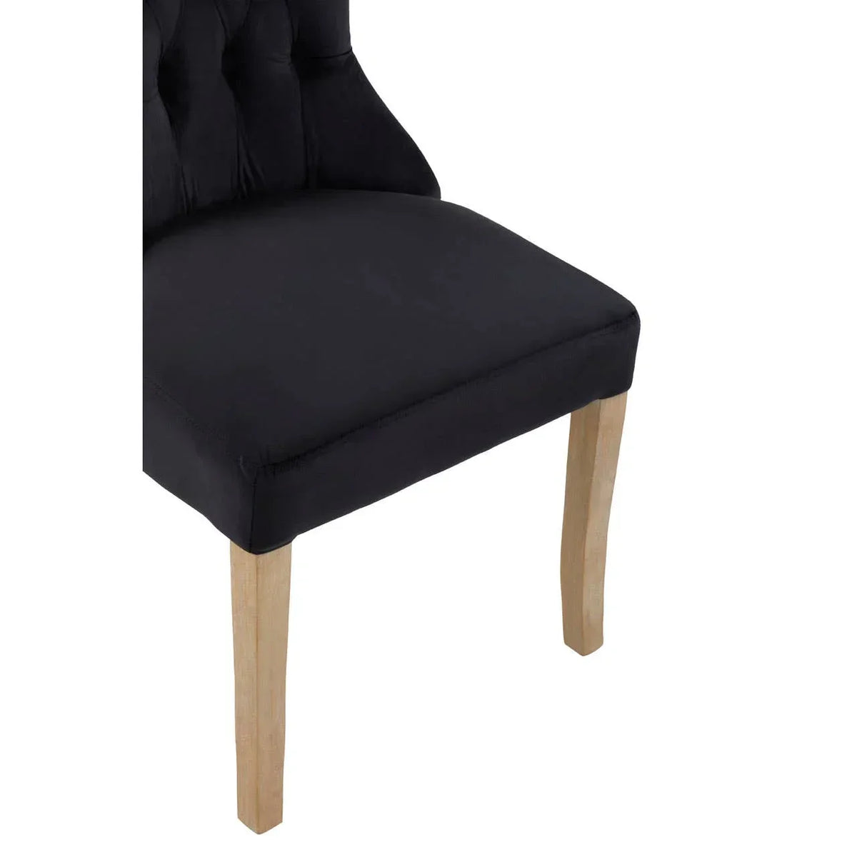 Black upholstered dining chair with wooden legs, partial side angle
