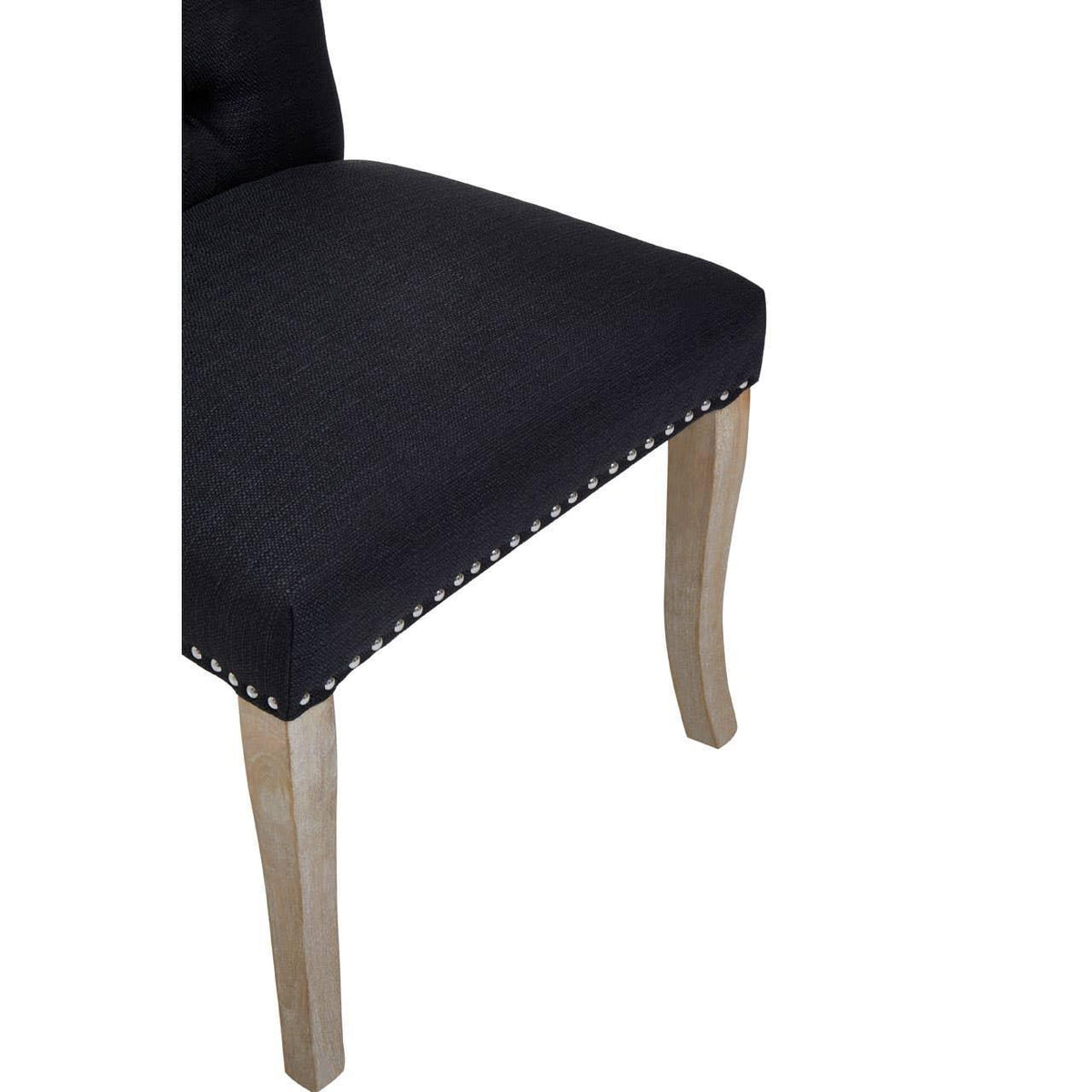 Black upholstered dining chair seat with nailhead trim and light wood legs