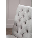 Light grey fabric dining chair with deep button tufted backrest, closeup angle