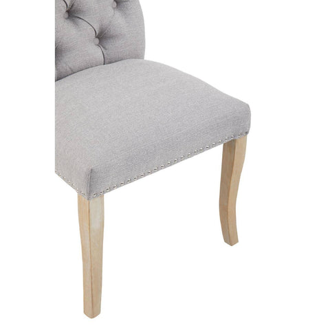 Light grey fabric dining chair with studded trim and natural wooden legs