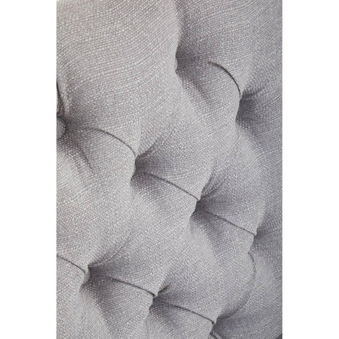 Grey upholstered headboard tufted fabric detail close up