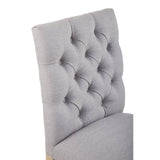 Grey fabric dining chair with button tufted backrest, close-up on upholstery detail