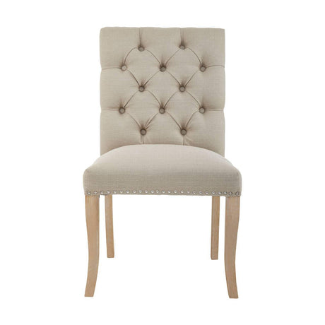 Beige upholstered dining chair with button tufted back and nailhead trim, light wood legs