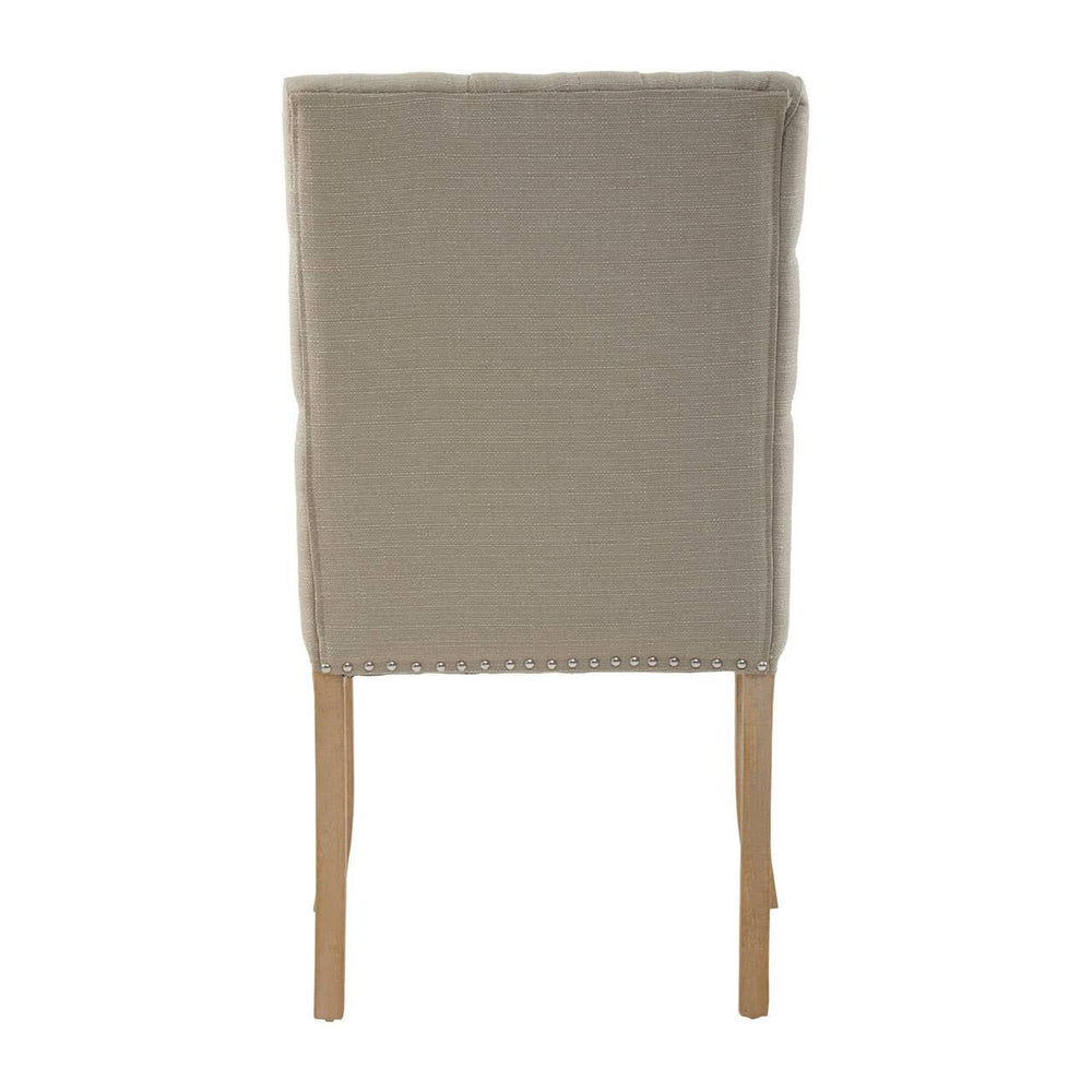 Beige upholstered dining chair rear view with wooden legs and silver stud detailing