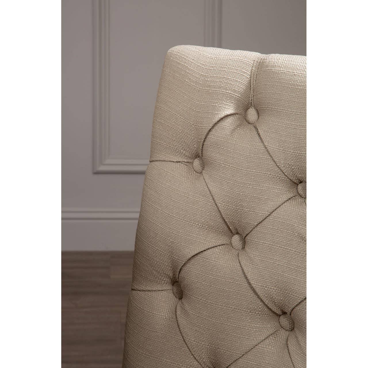 Beige fabric dining chair with button tufted backrest detail