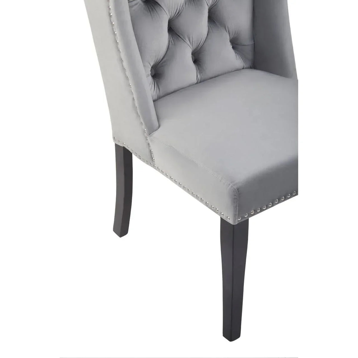 grey velvet dining chair with button tufting and silver stud trim, angled front view