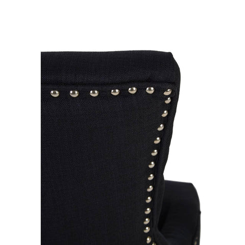 Black fabric chair back with silver stud detailing, close up showing upholstery texture