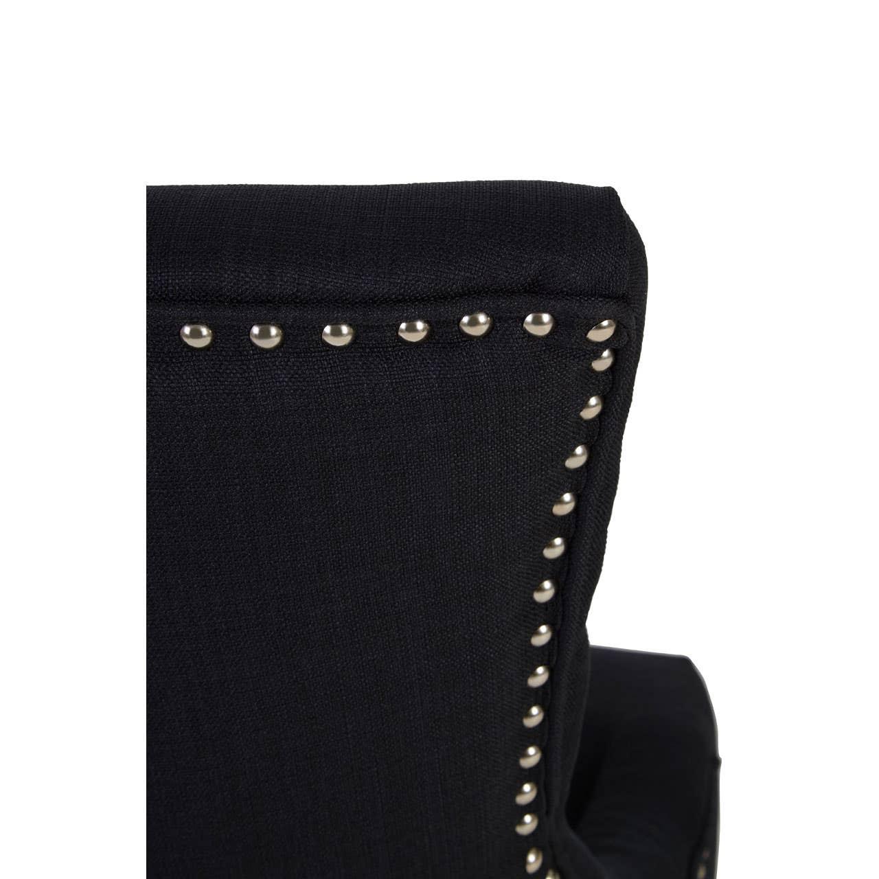 Black fabric chair back with silver stud detailing, close up showing upholstery texture