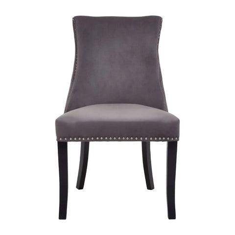 Grey velvet dining chair with studded trim and black wooden legs, front view