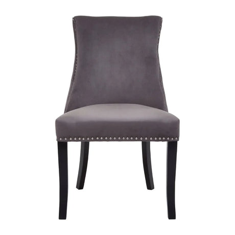 Grey velvet dining chair with studded trim and black wooden legs, front view