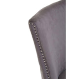 Grey velvet dining chair backrest with silver nailhead trim, close-up detail view