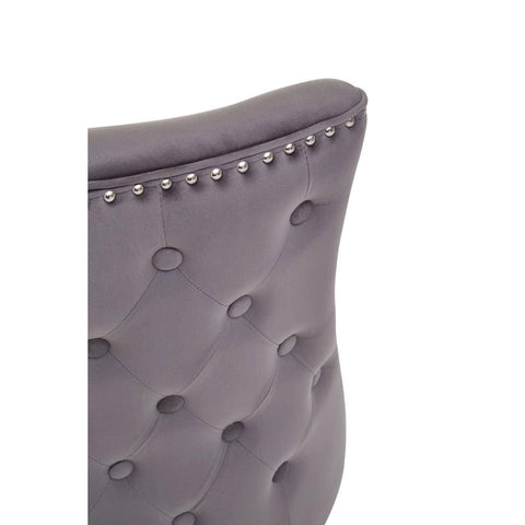 Grey velvet dining chair backrest with button tufting and silver stud detailing
