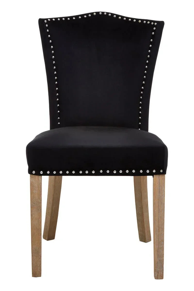 Black velvet dining chair with studded trim and light wood legs, front view