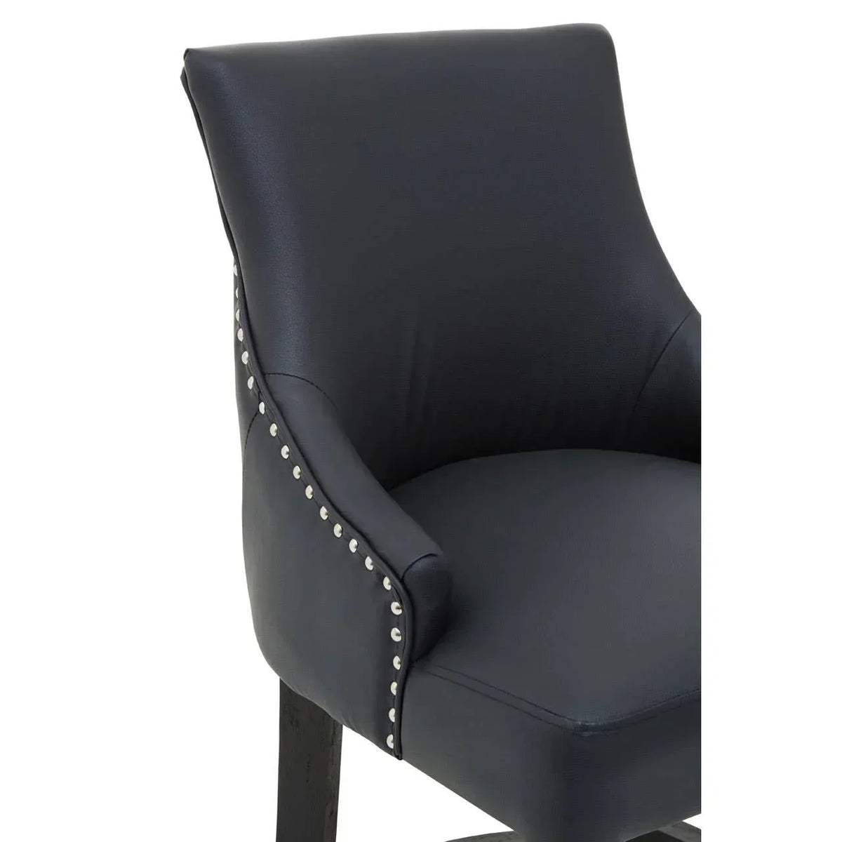 Black faux leather dining chair with silver stud detailing and wooden legs, side angle view