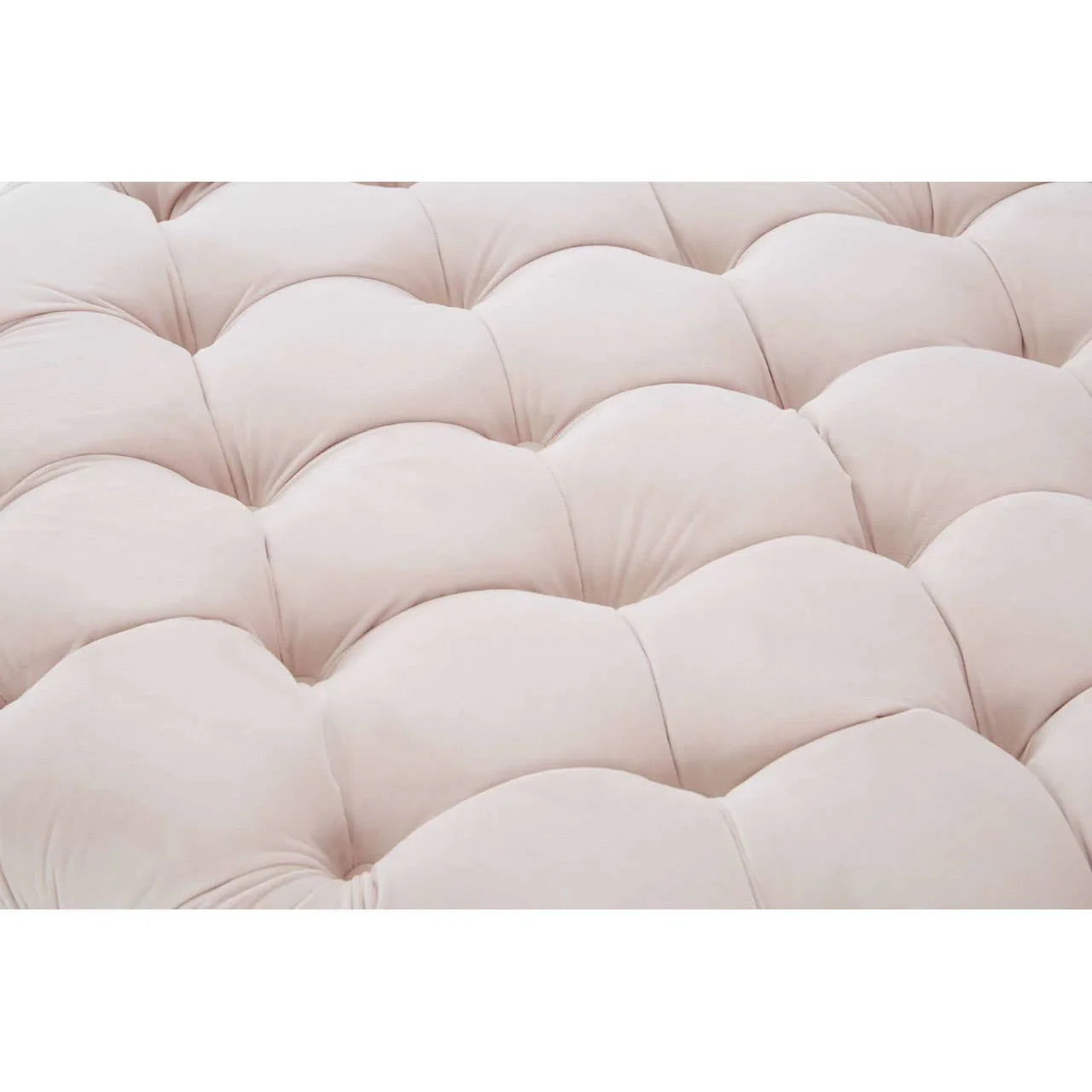 Closeup of cream tufted sofa upholstery with plush cushioned texture