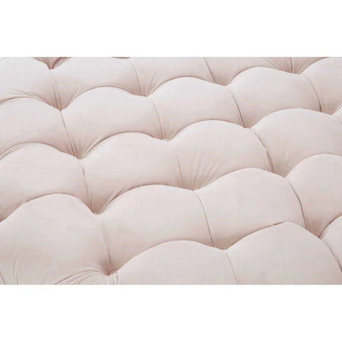 Closeup of cream tufted sofa upholstery with plush cushioned texture
