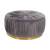 Round footstool upholstered in soft grey fabric with a tufted design, featuring a sleek gold base that adds a touch of elegance