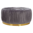 Round footstool upholstered in soft grey fabric with a pleated design, featuring a sleek gold base that adds a touch of elegance