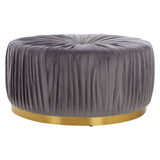 Round footstool upholstered in soft grey fabric with a pleated design, featuring a sleek gold base that adds a touch of elegance