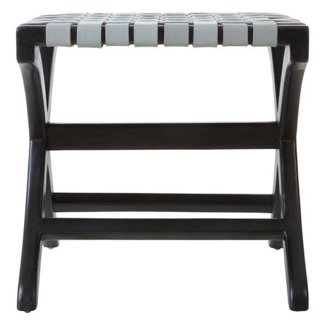 A grey leather stool with a woven seat design, supported by a sturdy black teak frame. The stool features a rectangular shape with a slatted top and crossbar support, showcasing a modern and minimalist aesthetic