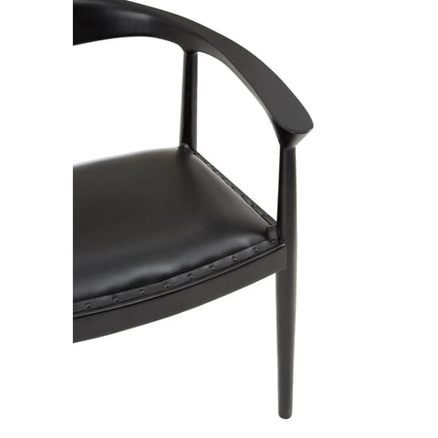 Black leather dining chair with curved armrest and stud detailing, partial side view