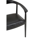 Black leather dining chair with curved armrest and stud detailing, partial side view