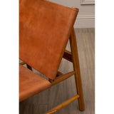Brown leather lounge chair with wooden frame on light wood flooring