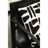 Black leather accent chair with modern black and white patterned cushion