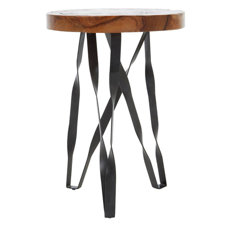 Round teak wood stool featuring intricate carvings on the top surface, supported by a unique black metal base with twisted legs, creating a modern and artistic design